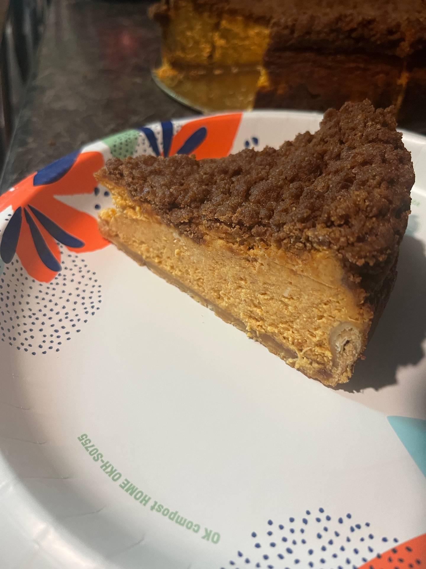 A slice of pumpkin sopapilla cheesecake with a thick cinnamon crumb top